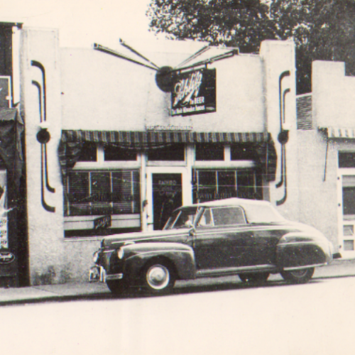 Historic building with old car in front