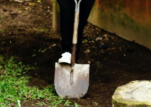 Shovel digging into dirt