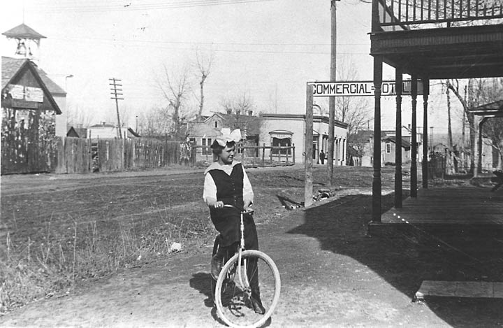 Girl on bike outside hotel on Pine Street