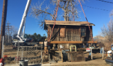 One of the Trott-Downer Cabins being moved by crane in 2018