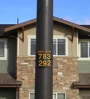 Light Pole in front of home with closeup of ID numbers