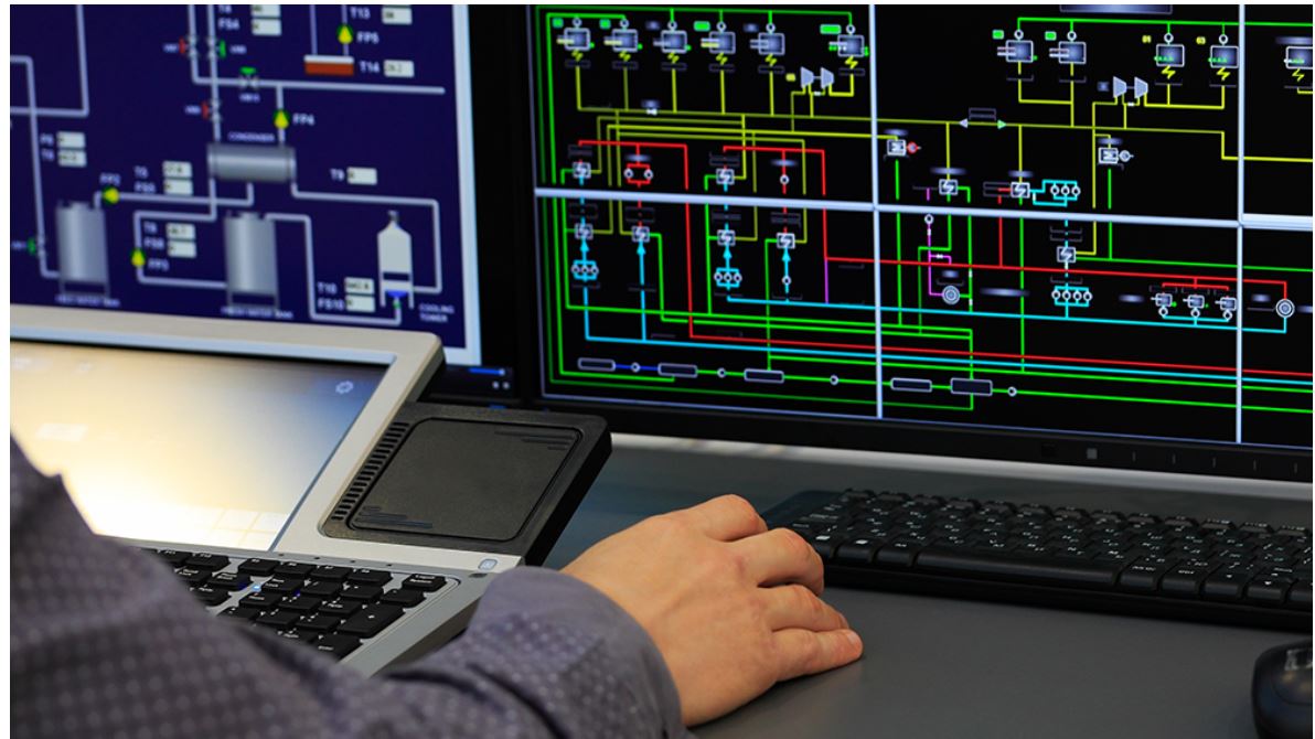 person sitting in front of SCADA screens on computer screen