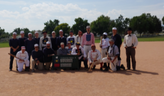 Vintage baseball team posing in uniforms with the scroeboard