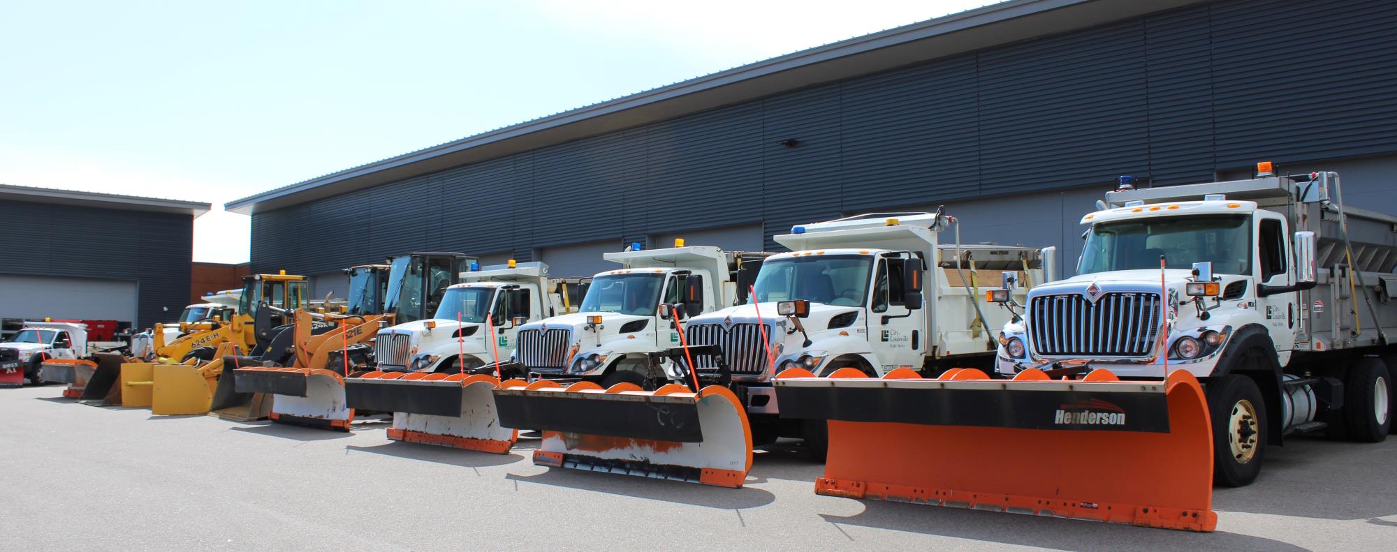 row of snowplows at City Services building