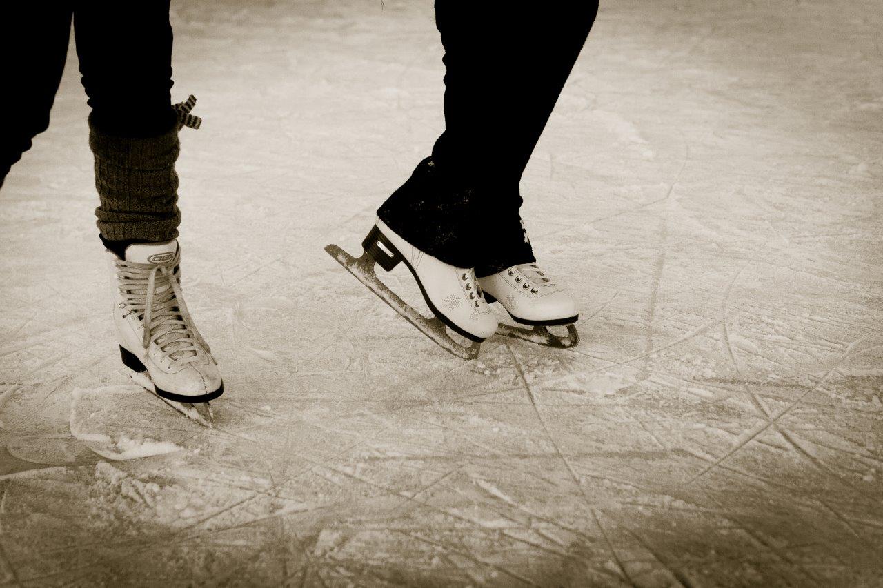 Feet and ice skates of skaters