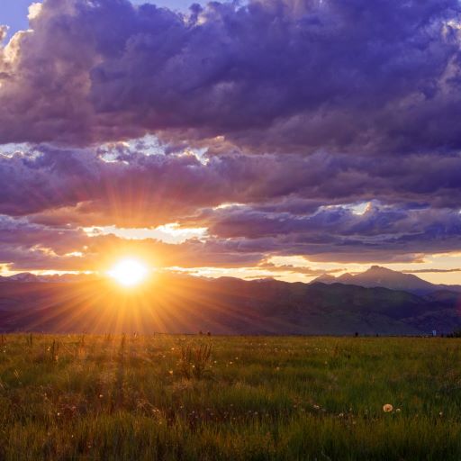 Sun setting over mountains and prairie