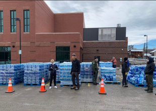 Recovery workers distributing bottled water