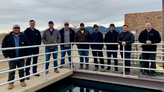 group of men standing in a line at water treatment