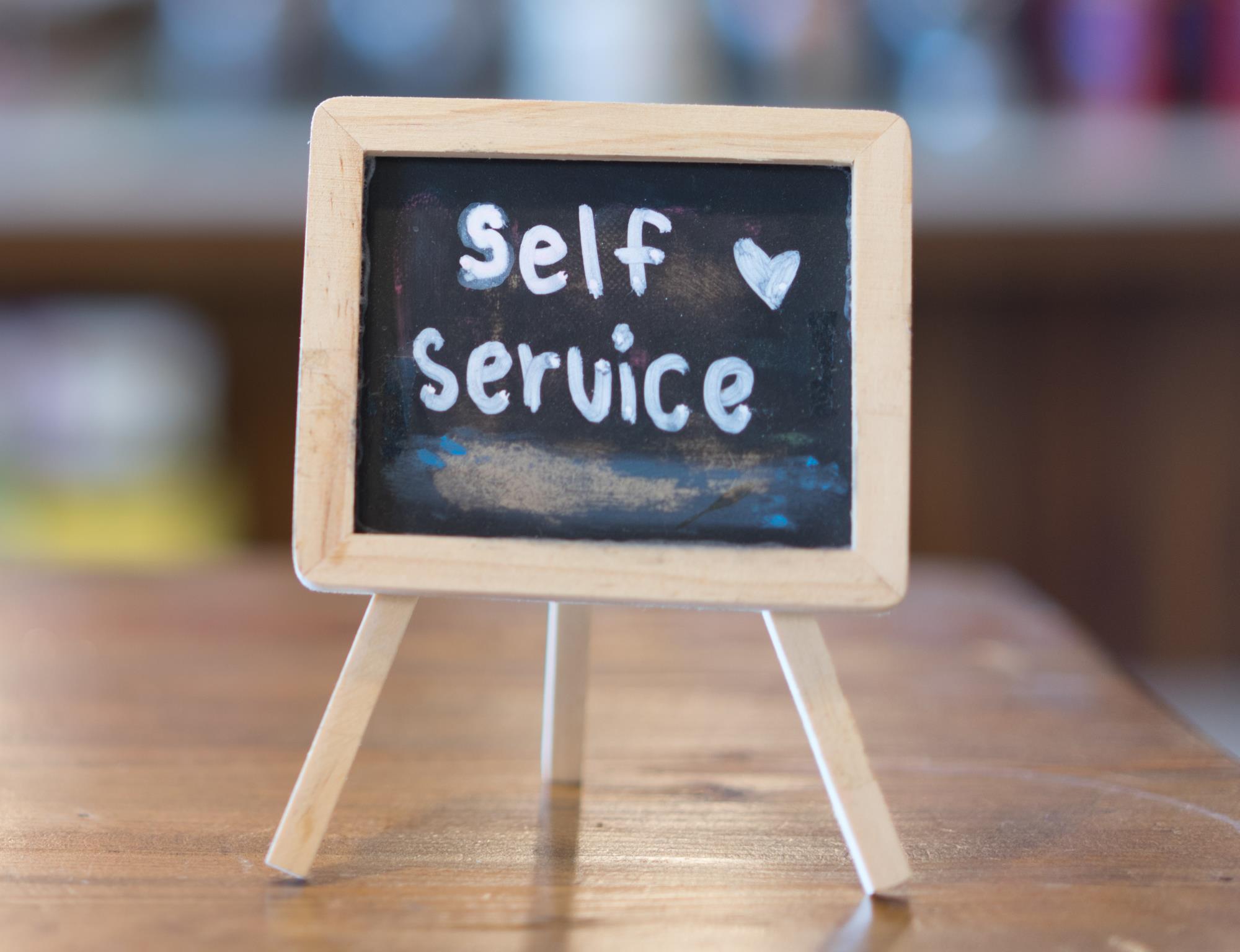 SELF SERVICE sign on a table chalk board