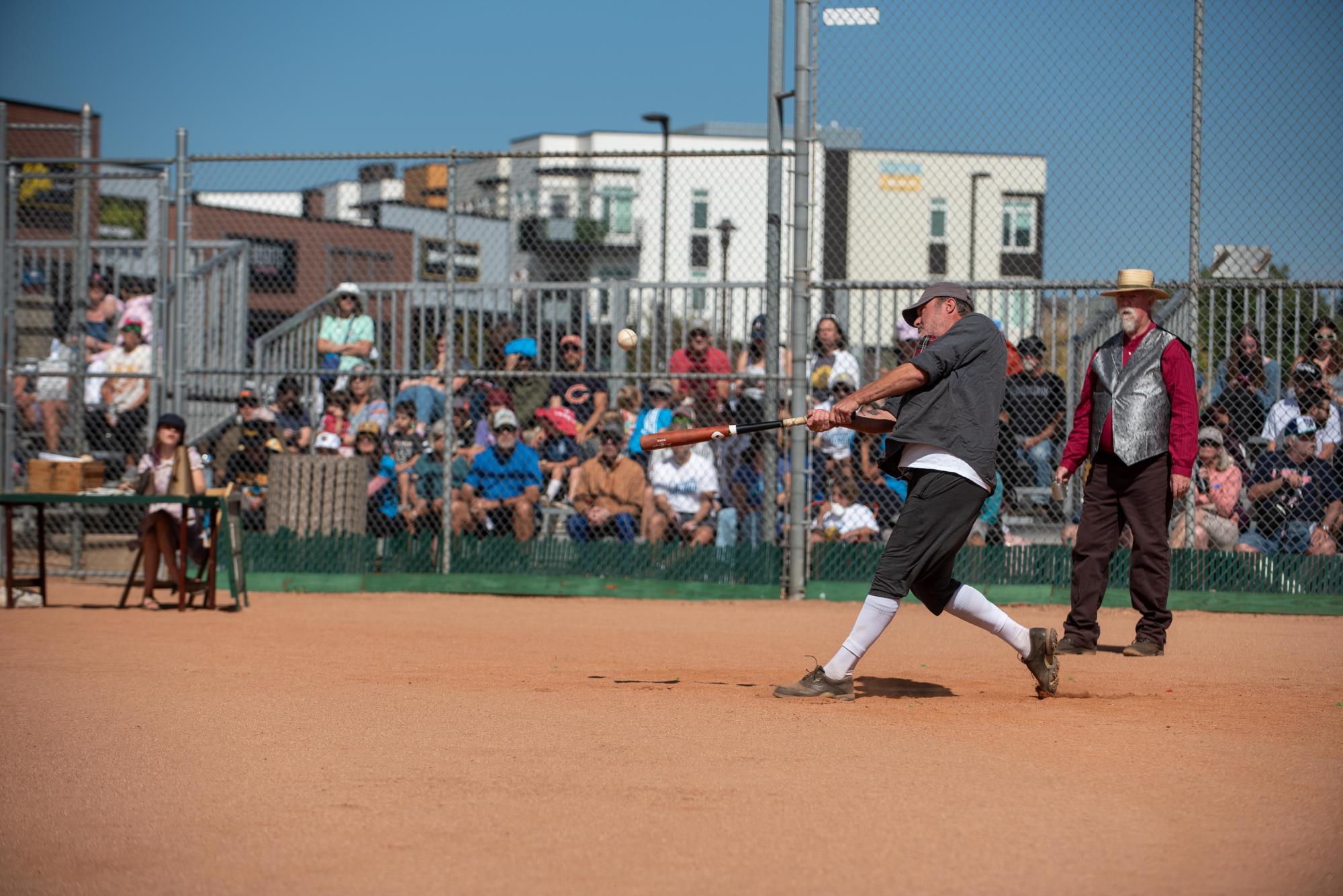 A base ball player swings at a ball