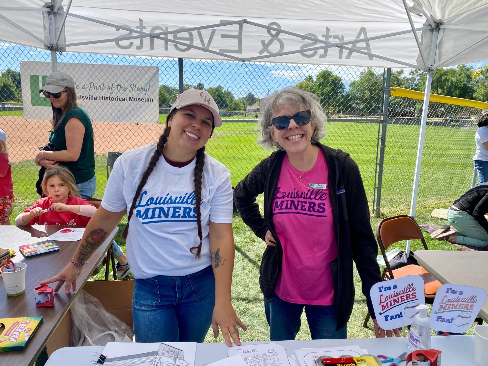 Volunteers in Louisville Miners Tshirts smile